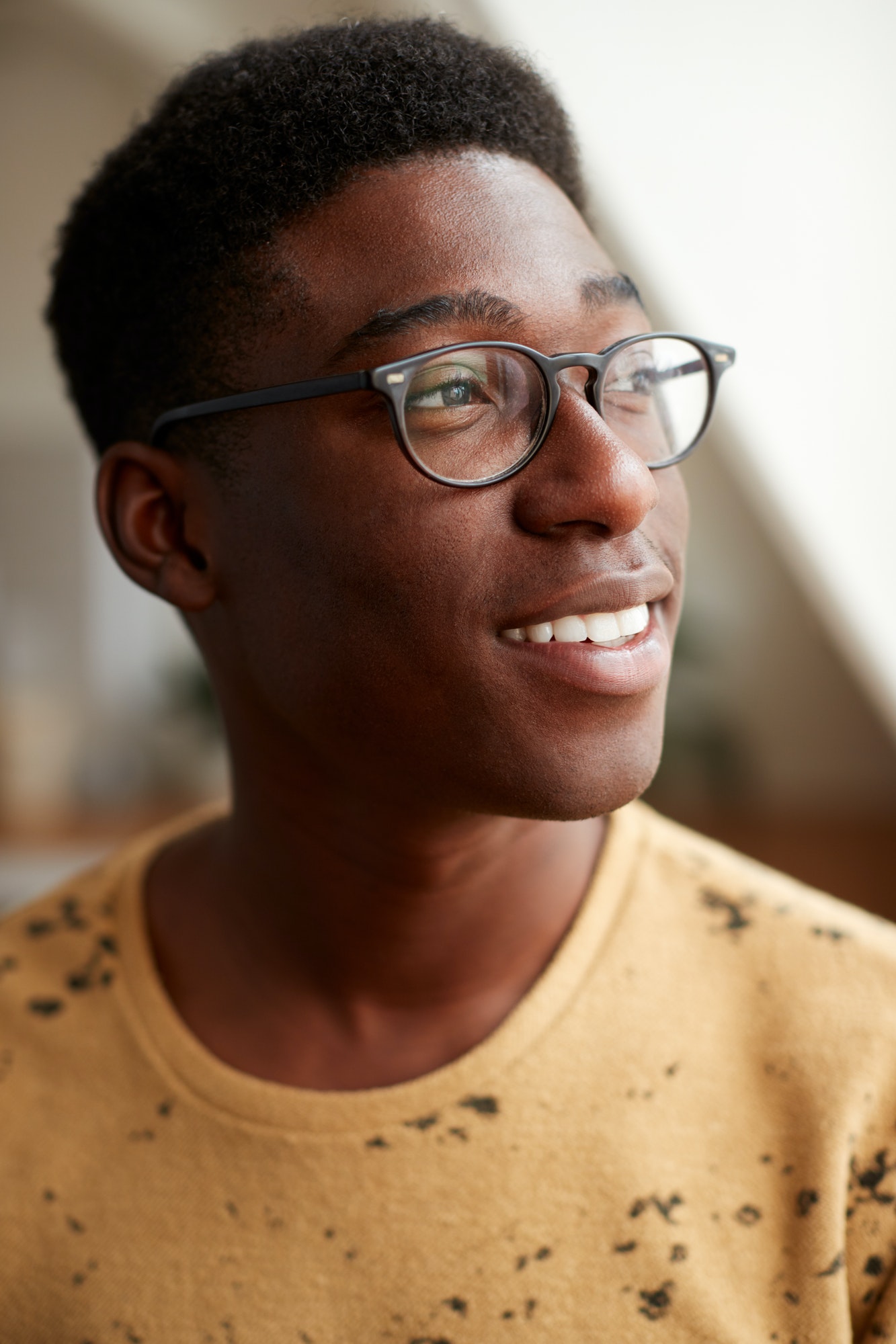Young Man Wearing Glasses In Loft Apartment